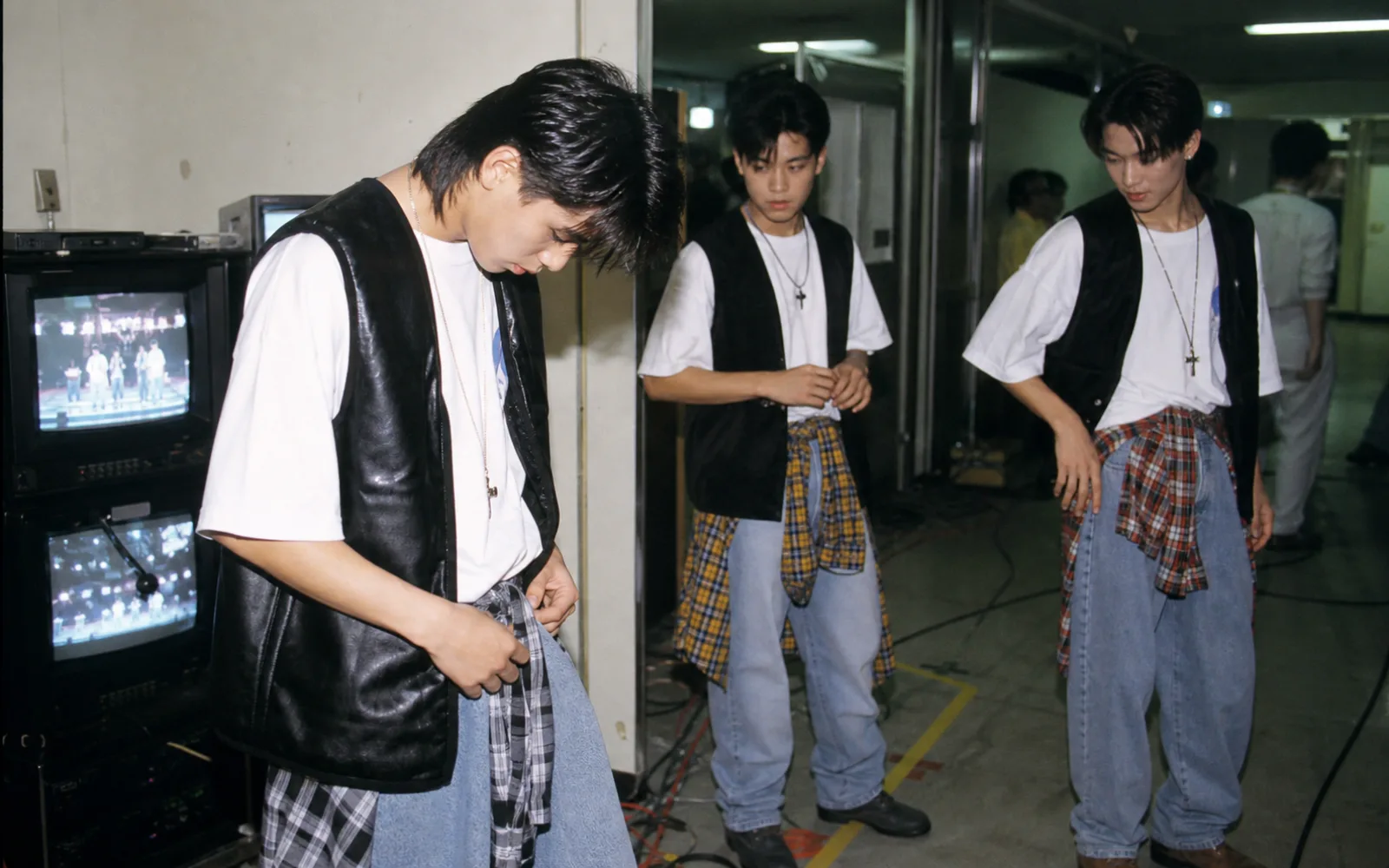 Editorial reconstruction of three early-1990s Korean performers preparing in a television studio corridor