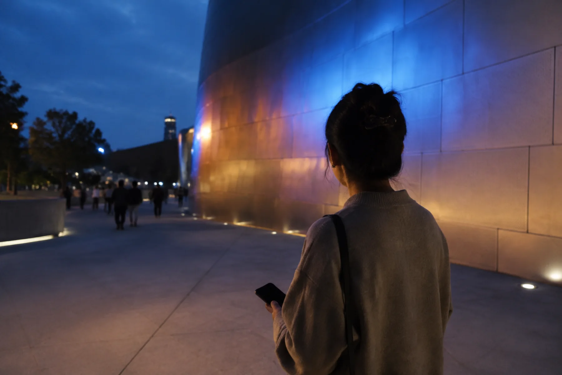 AI-generated editorial view of an anonymous adult lowering a dark-screen phone while looking at abstract light on a fictional curved civic wall