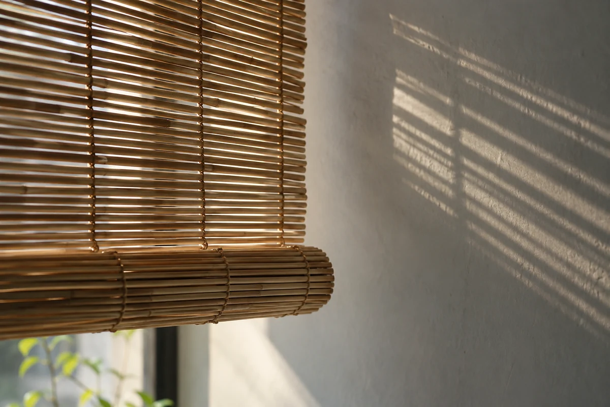 Conceptual fine bamboo screen with thread ties and filtered daylight