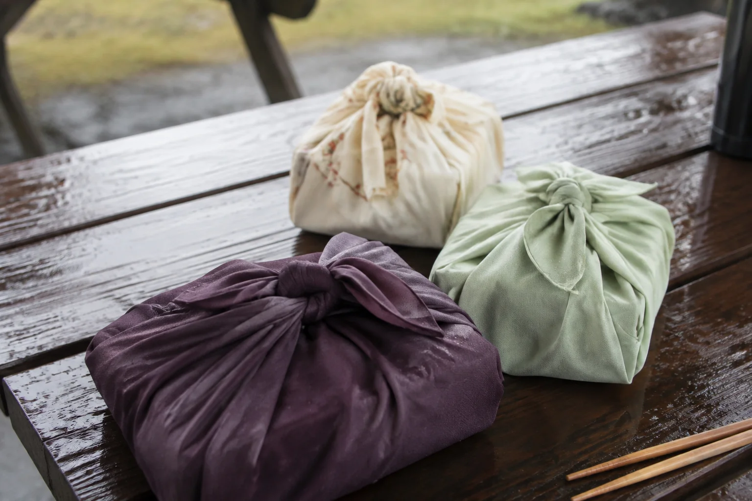 Cloth-wrapped bundles on a wooden picnic table.
